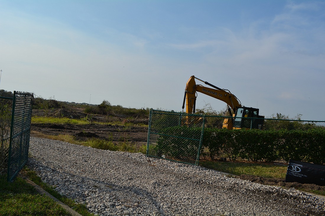 Bulldozers have begun clearing land immediately west of Grand Harbour Parkway and north of State Road 64. Equipment is using existing stub-outs in the road to access the property.