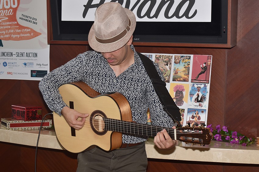 Renesito Avich performs live music during the cocktail and shopping hour.