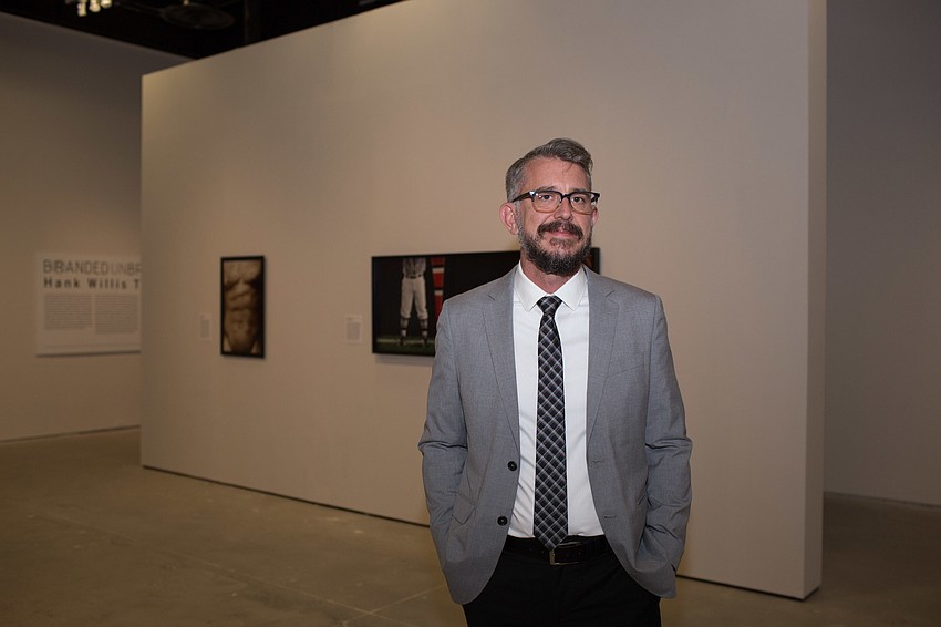 Curator Chris Jones inside the Hank Willis Thomas: Branded/Unbranded exhibit.