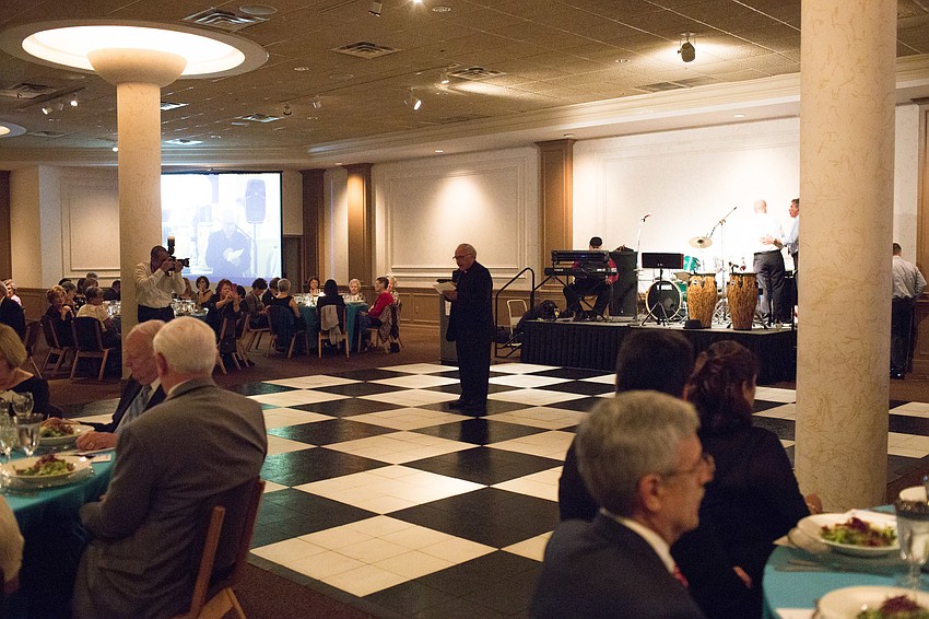 Father Celestino Gutierrez says a prayer before dinner.
