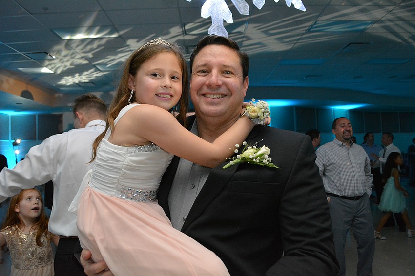 Isabella Novas gets a lift from her dad, Kevin, because her feet started hurting.