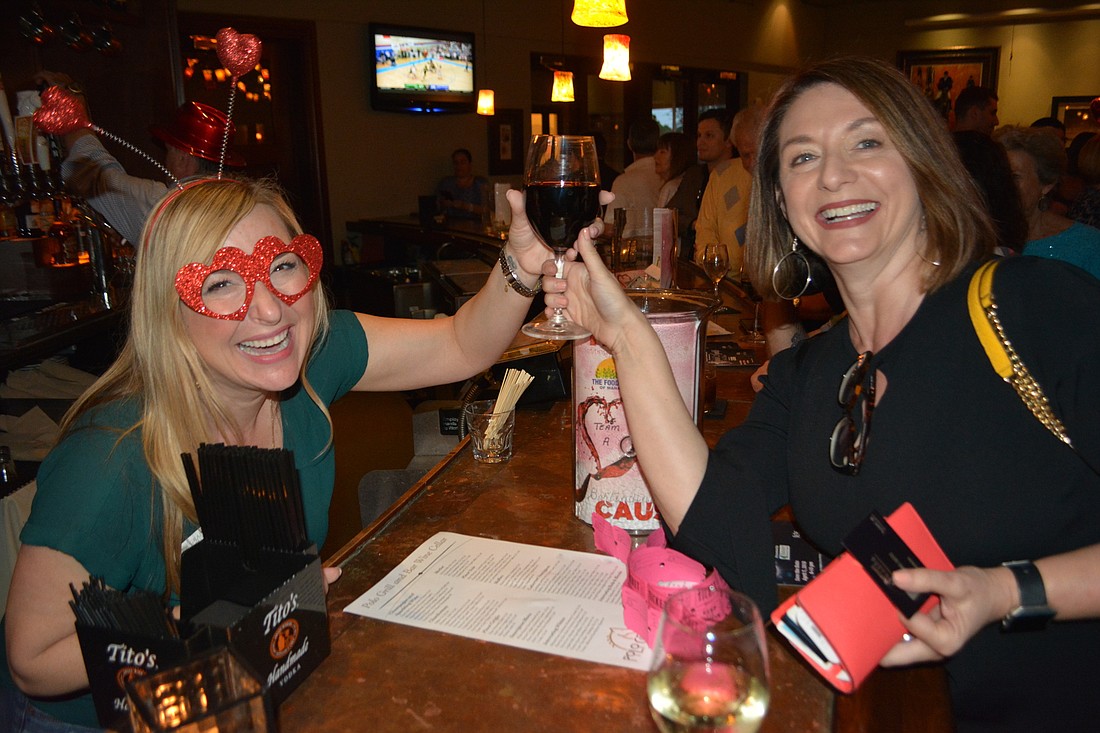 Allison Imre, the owner of Grapevine Communications, enjoys her role as a celebrity bartender as she serves Venice&#39;s Lynn Massaroni during "Bartending for a Cause" at the Polo Grill & Bar in Lakewood Ranch.