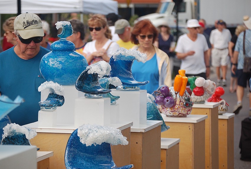 Patrons slowed to look over the sculpture of Josh Fradis.