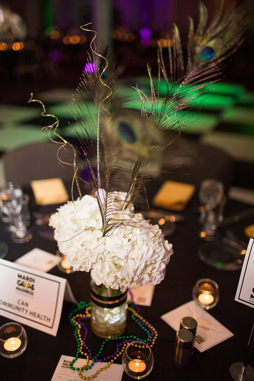 Peacock feathers and flowers centered the tables.