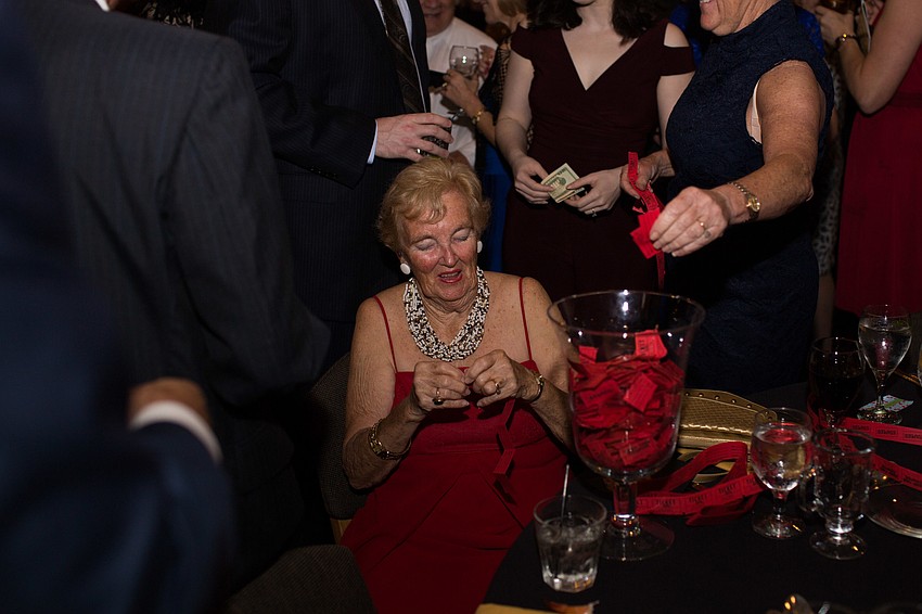 Ellie Gooch divides raffle tickets and places them in the jar.