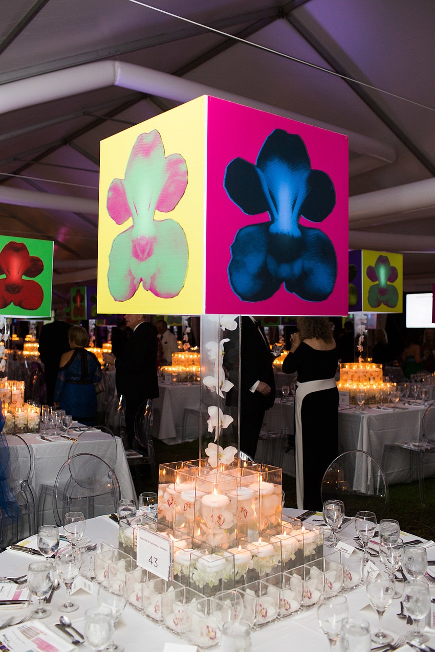 The large centerpieces featured orchids floating in water with candles and a Warhol inspired top.