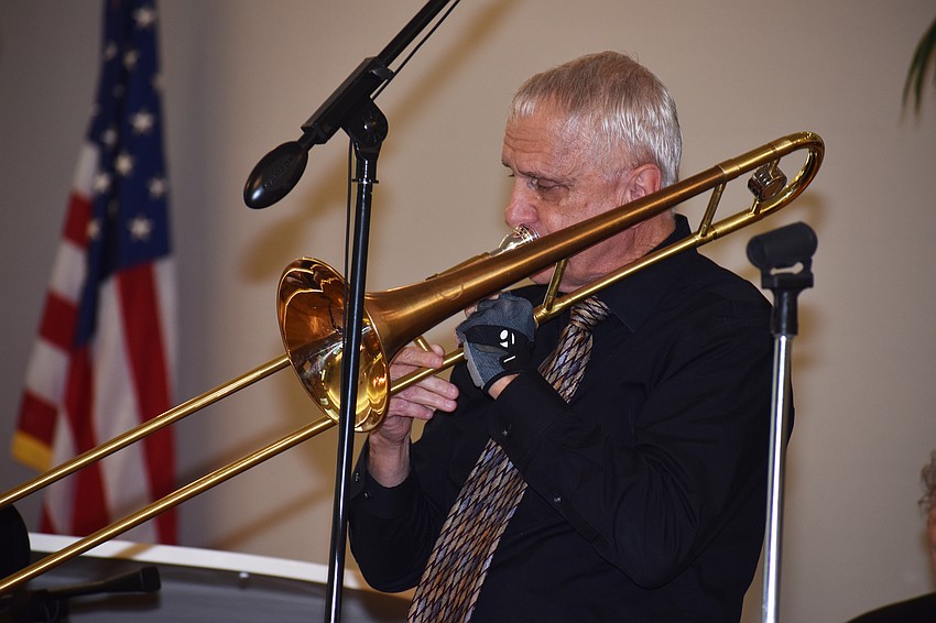 Herb Bruce plays the trombone during the service.