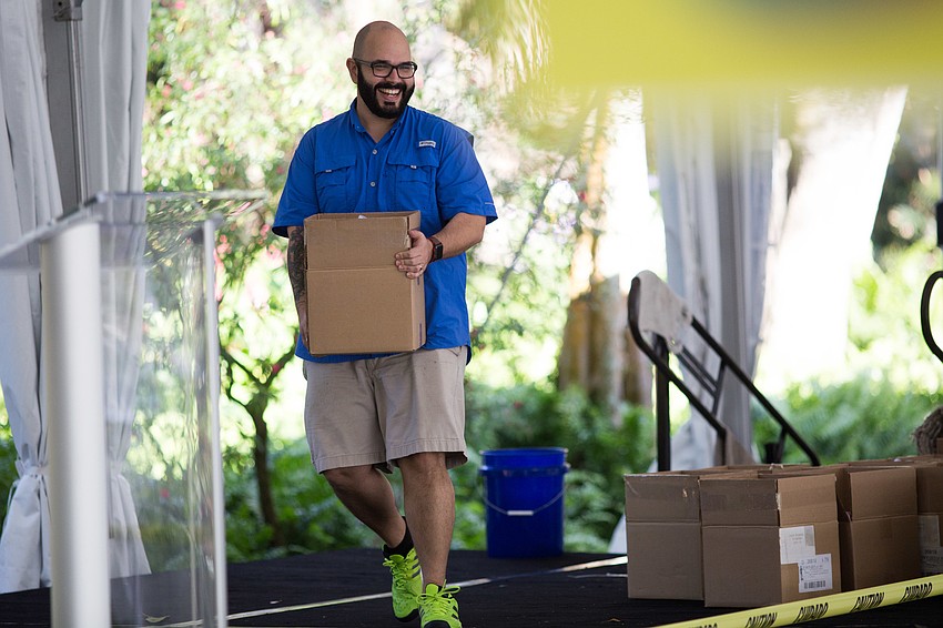 Capote laughs with everyone helping to get set up the event. The boxes were filled with the Andy Warhol “Flowers” books.