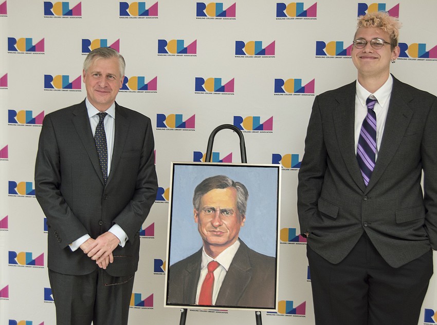 Jon Meacham and Ringling College illustration junior James Smolko pose with the portrait Smolko painted.