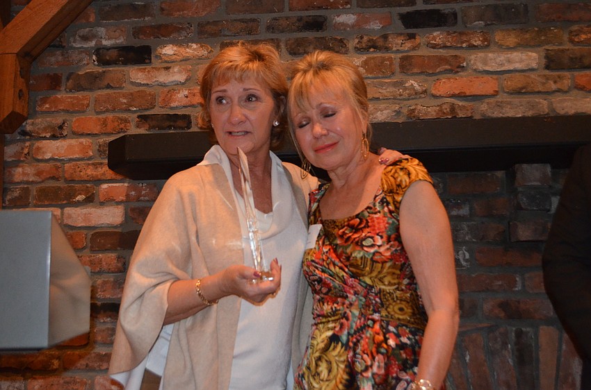 County Commissioner Vanessa Baugh presents the Humanitarian of the Year of award to an emotional Diane Brune.