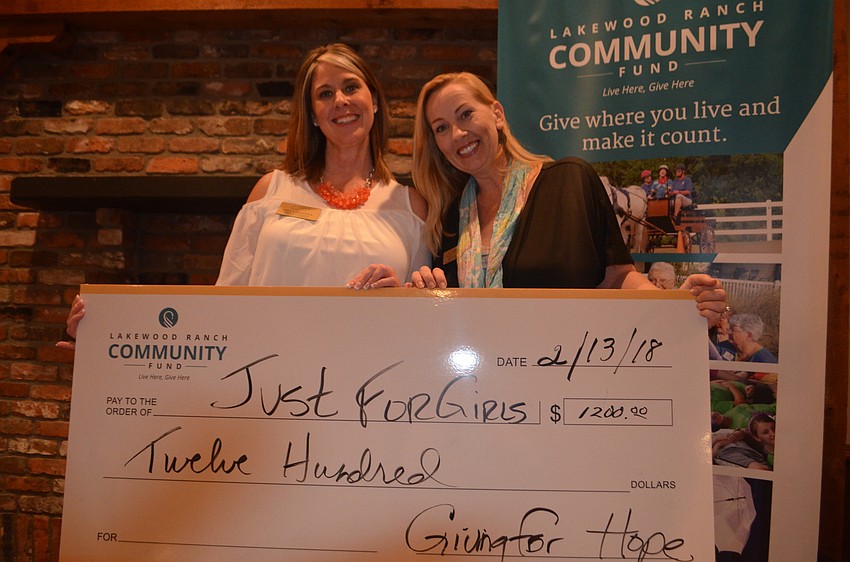 Ann Colonma and Andi Watson from Just for Girls pose with the check presented to their nonprofit at GALentine's.