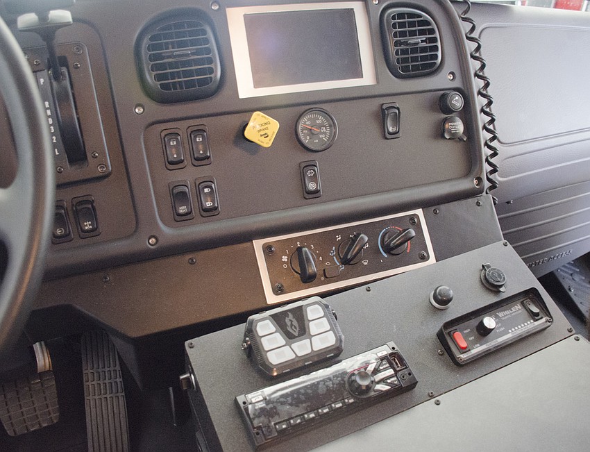 The center console has a couple amenities found in most vehicles — two cup holders and a radio — but many that can only be found in an emergency response vehicle.