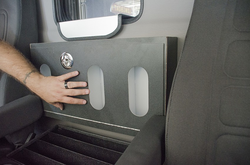 A customized box behind console providing easy access to three boxes of latex gloves;