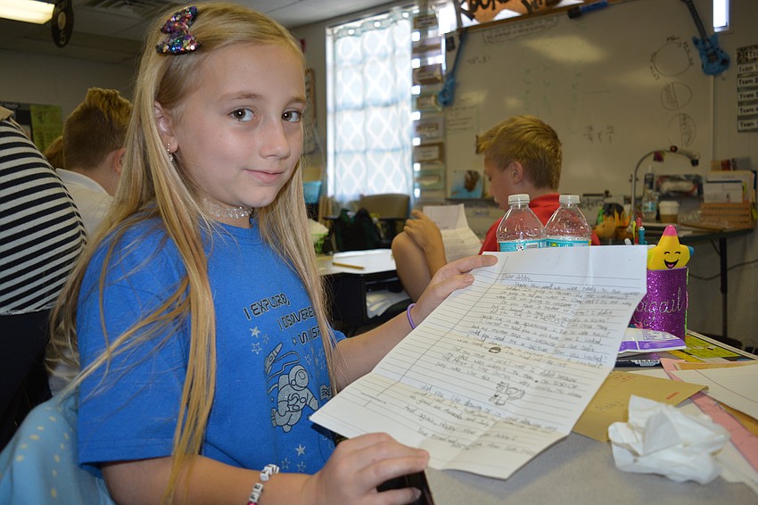 Abby Burns with her letter, with the picture her pen pal drew her.