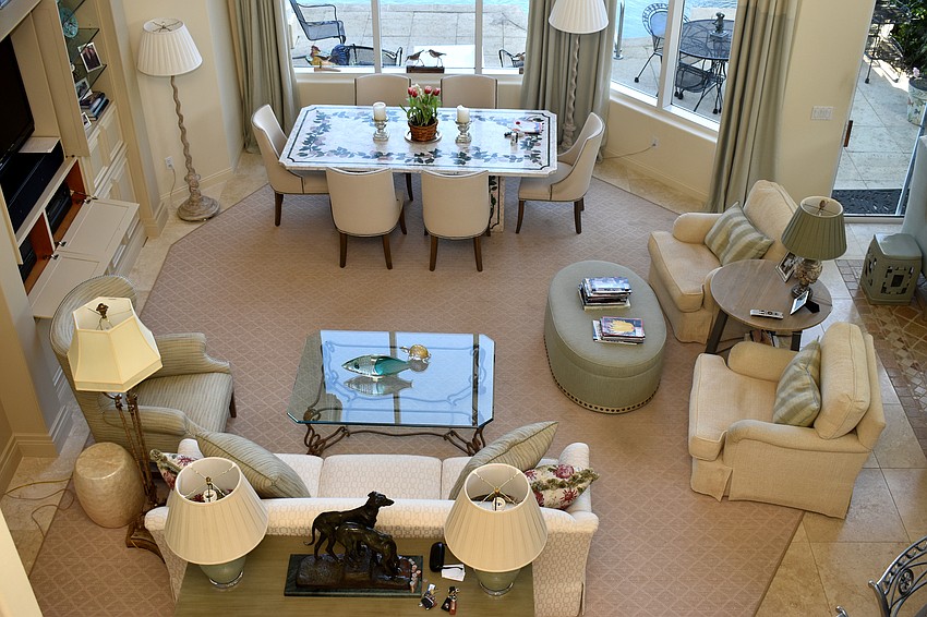 A great room off of the kitchen features a seating area and table with views onto an inlet of Sarasota Bay.