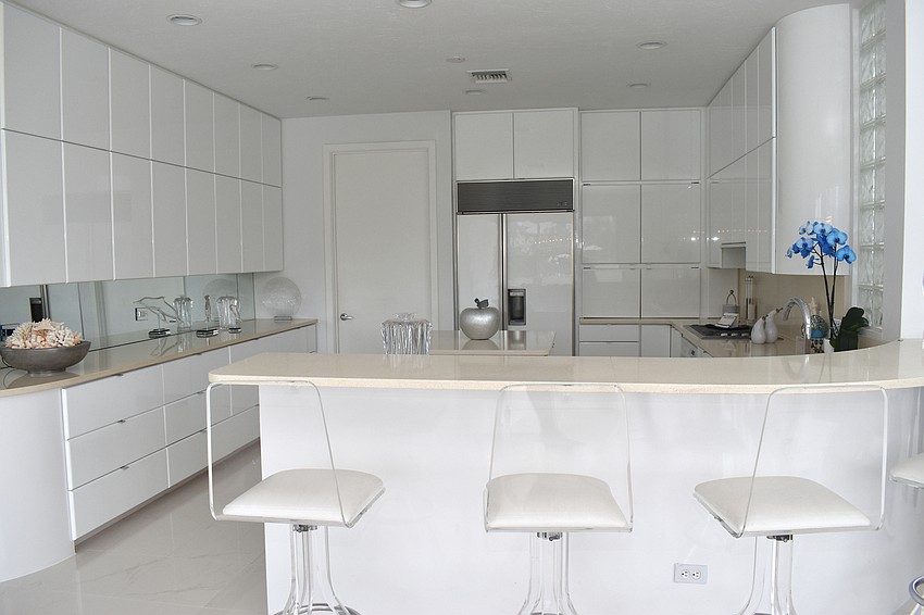 The all-white kitchen is located on the second floor.
