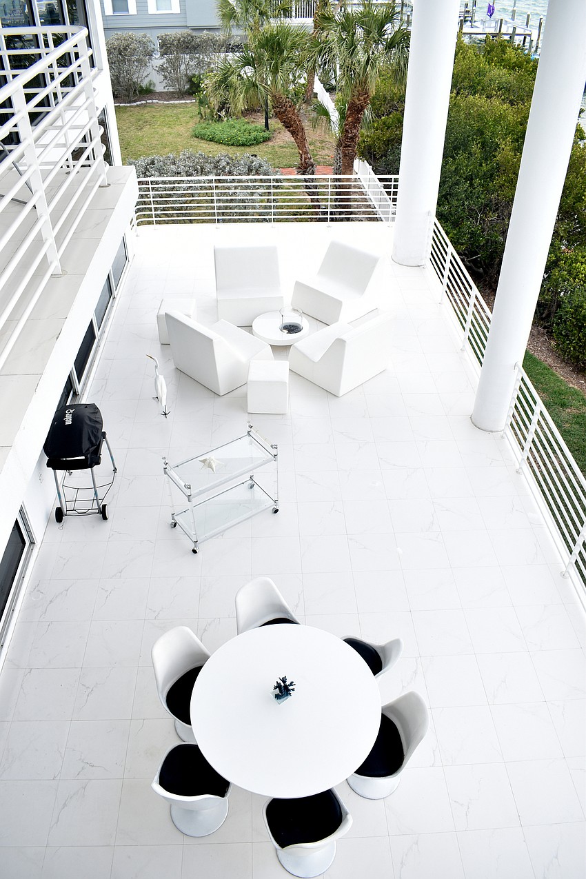 An outside patio features seating, grill and drink cart.