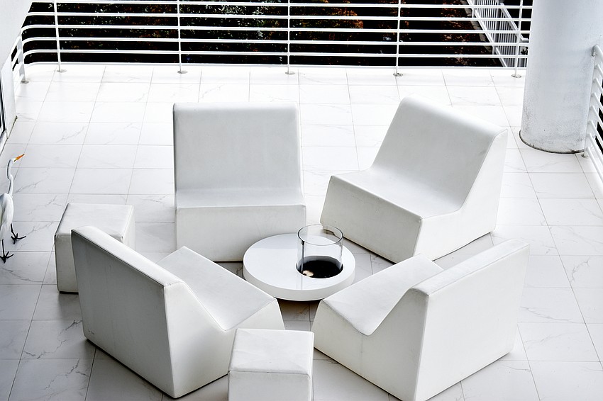 An outside patio features seating, grill and drink cart.