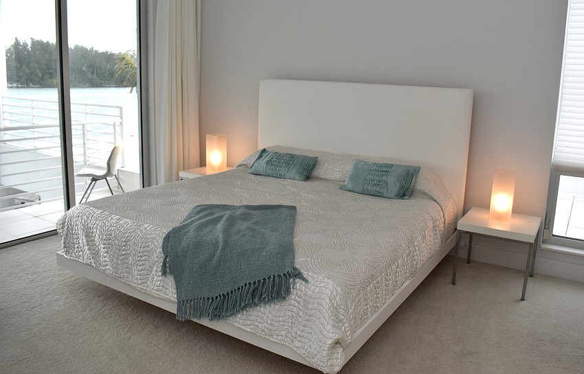 Another guest room with blue accents is situated on the third floor with a patio.