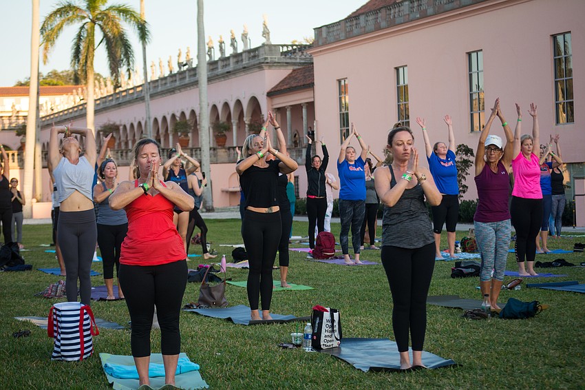 Yoga participants meditate as the sun goes down.