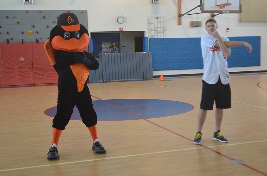 The Bird stretches with Orioles pitcher Brad Brach.
