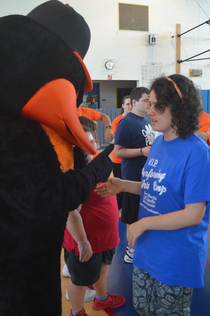The Bird shakes hands with Oak Park School student Samantha Martin after the workout.