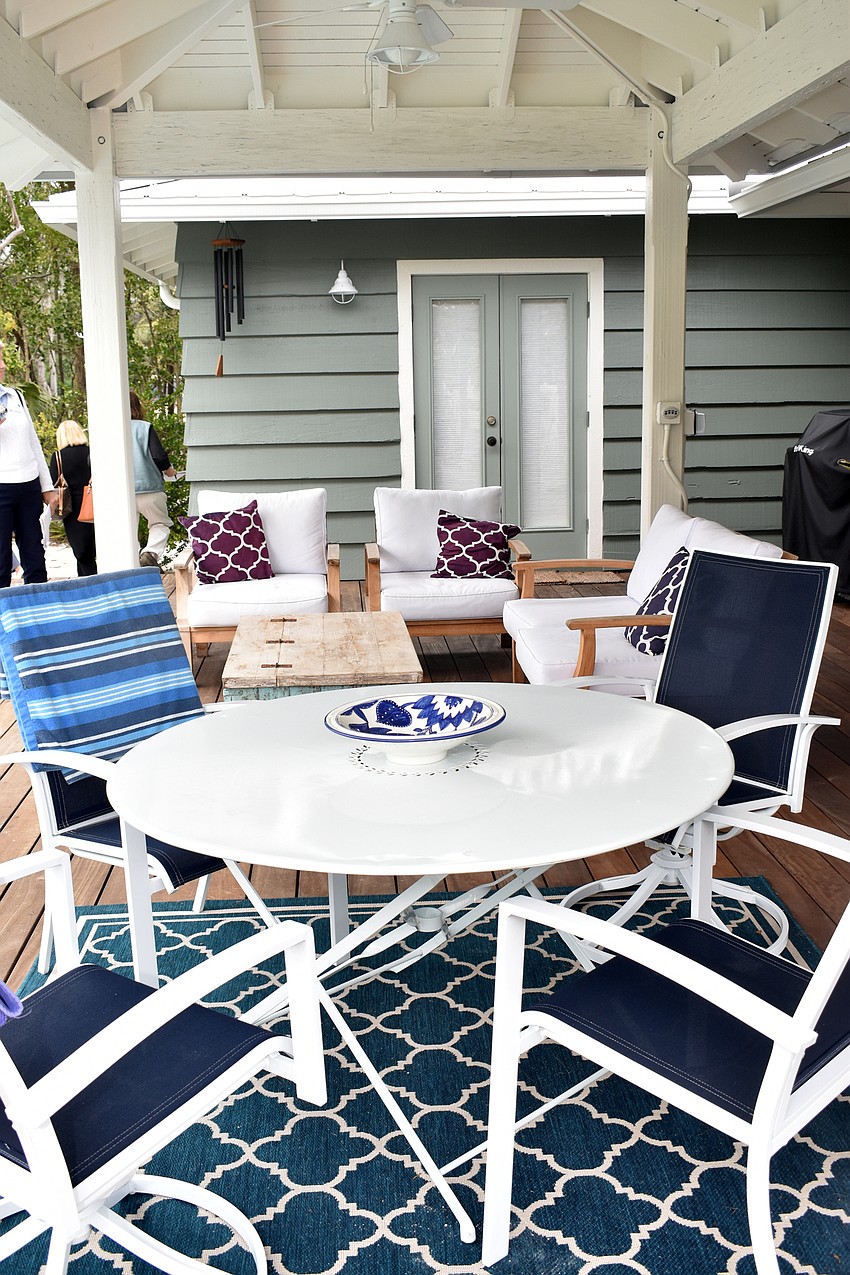 Outside, a wooden patio complete with seating is used for relaxing and entertaining.