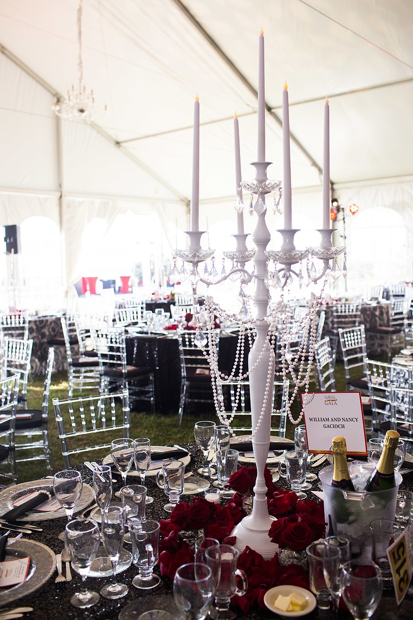 A white candlestick adorned each table.