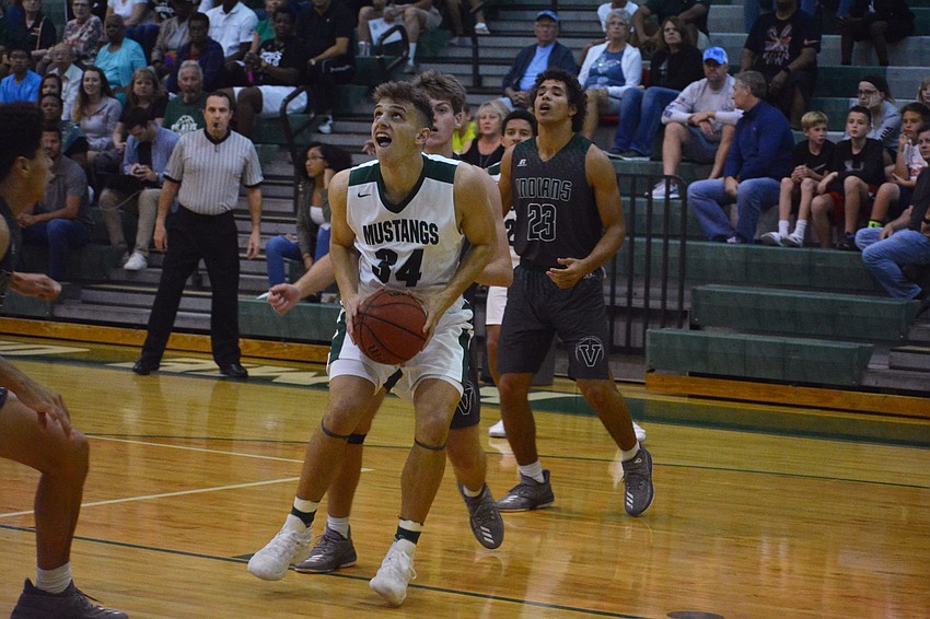 Senior Jack Kelley fights through traffic in the paint after grabbing a rebound. Kelley finished with eight points.