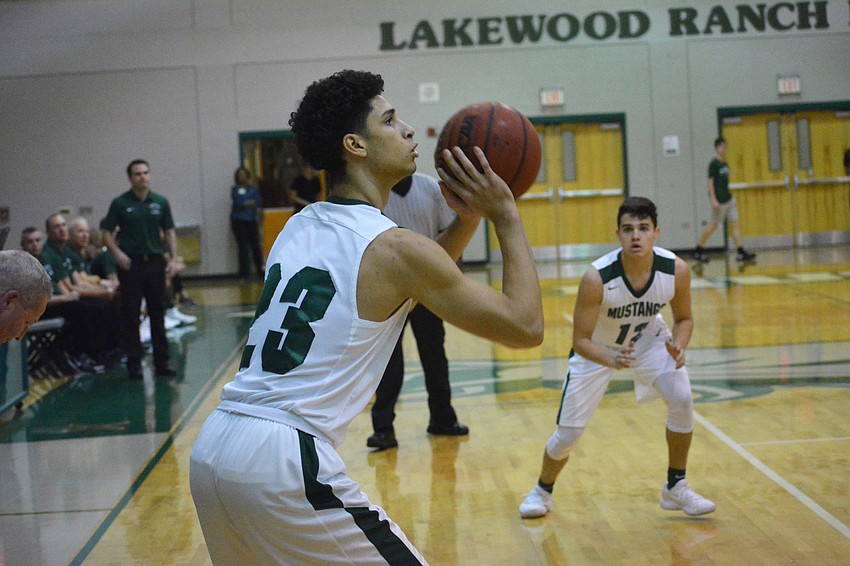 Sophomore Christian Shaneyfelt lines up a three-point attempt. He had 11 points on the night.