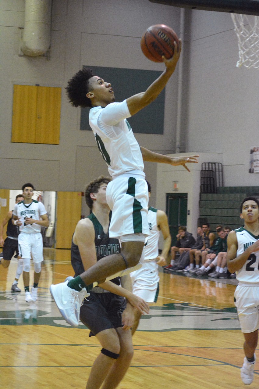 Damien Gordon adjusts in the air to hit a finger roll.