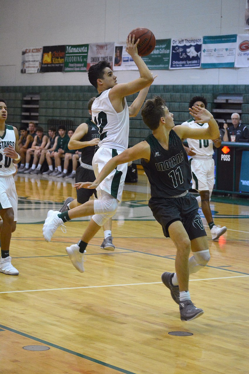 Junior guard Mark Caraher sinks a shot in the third quarter of the district championship game.