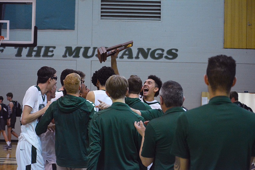 The Mustangs jump around after winning the district title.