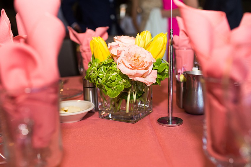 The centerpieces were bright pink and yellow flowers on a bed of clover.