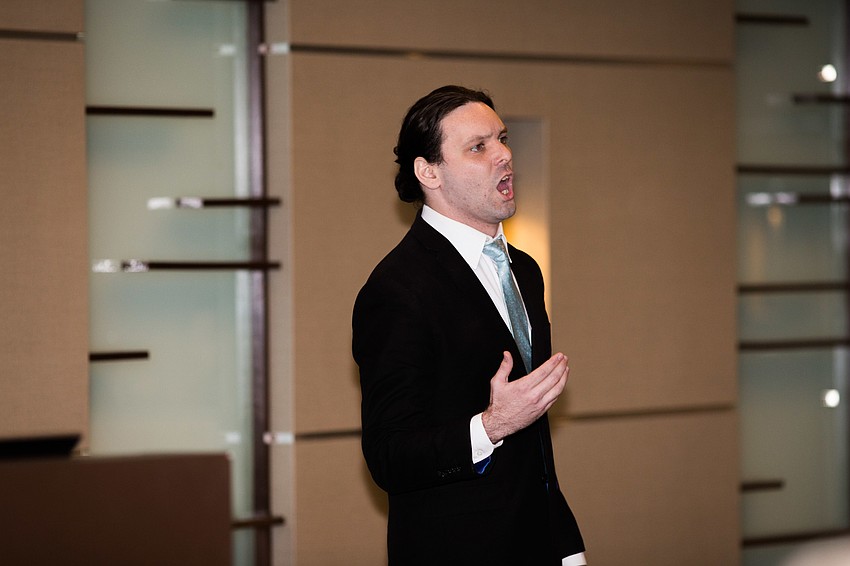 Thomas Massey, a tenor, performs for the donors.