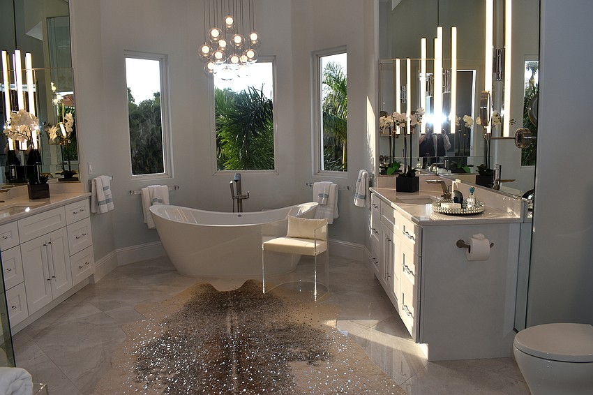 The master bathroom has two sinks, a bathtub and shower.