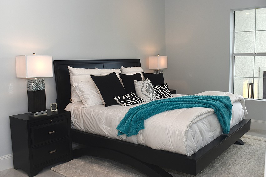 The two guest bedrooms have contemporary styles with black and blue hues.