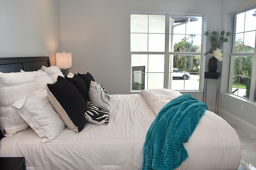 The two guest bedrooms have contemporary styles with black and blue hues.