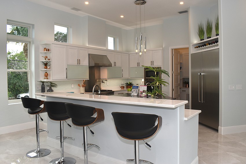 The kitchen, which has a center island, has Thermador appliances.