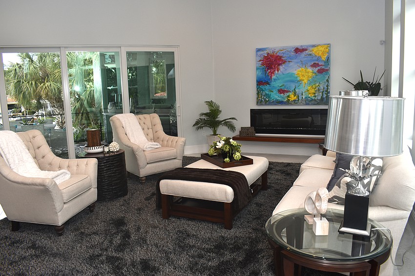 Off the kitchen, a living room decorated in a contemporary styles offers an entertaining space.