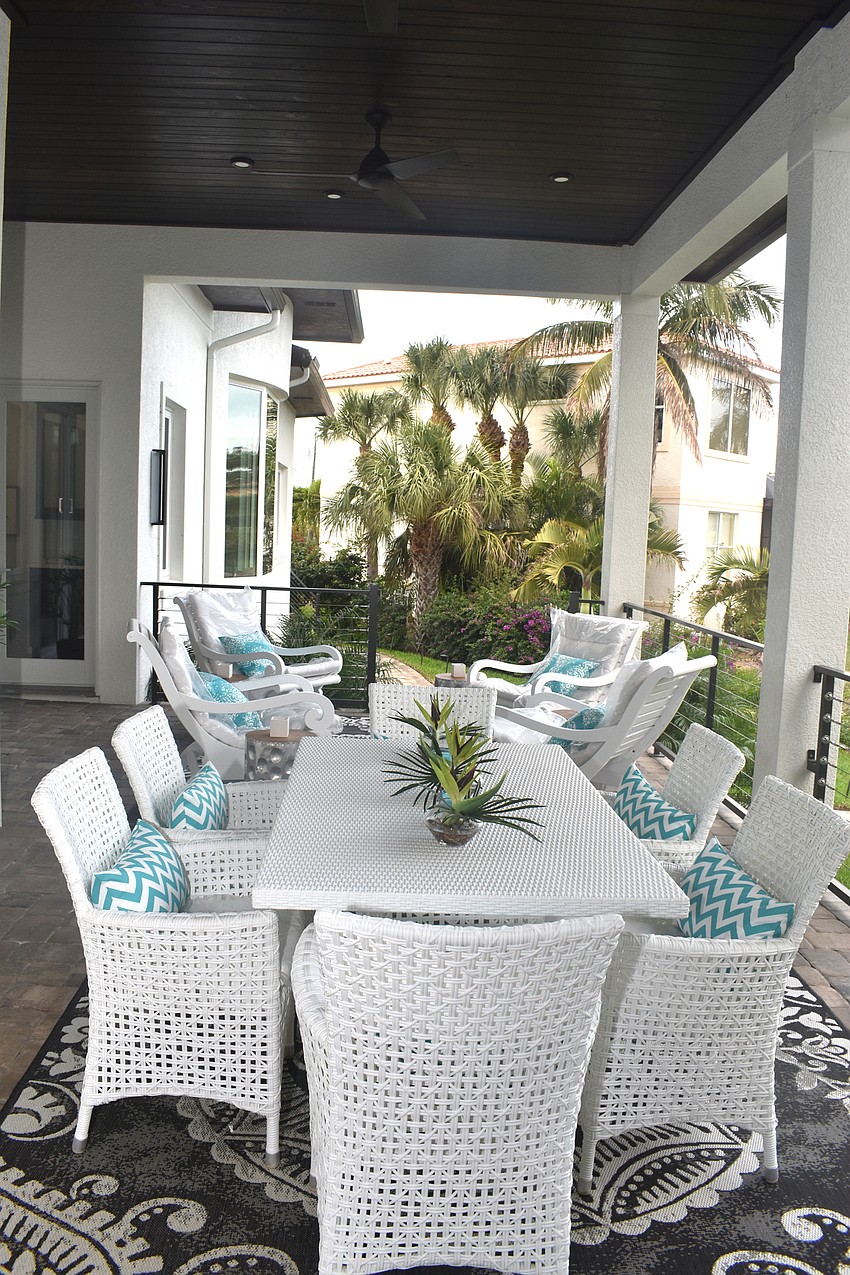 An outdoor patio looks onto the canal leading to Sarasota Bay.