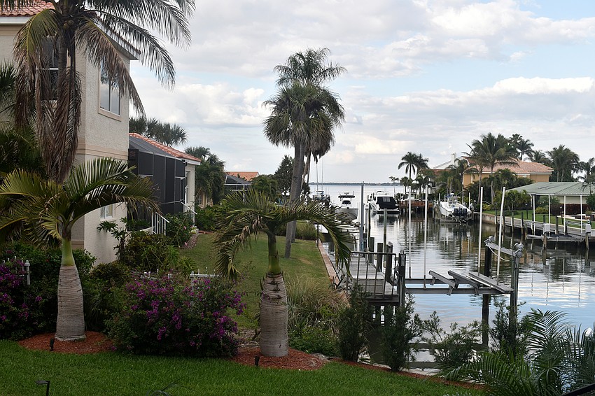An outdoor patio looks onto the canal leading to Sarasota Bay.