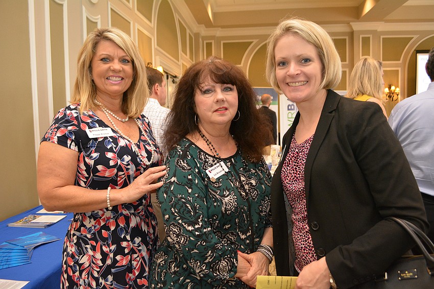 Willis Smith Construction's Peggy Kronus and Liz Brookins make sure to say hi to Bethany Carr, of Kerkering Barberio. Carr represented both Rotary and the Alliance at the event.