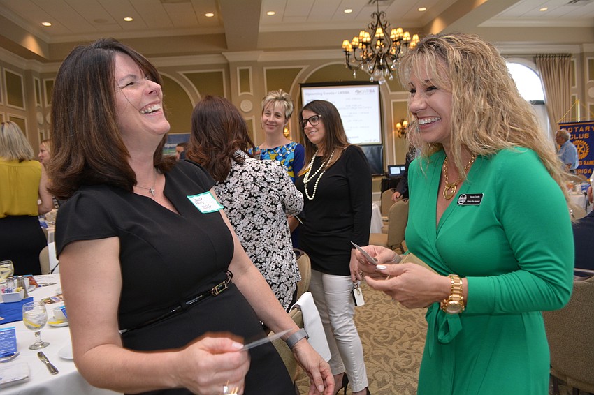Janelle Haas, of JDRF, swamps business cards with Stacey Carollo, of Windy CIty Apparel.