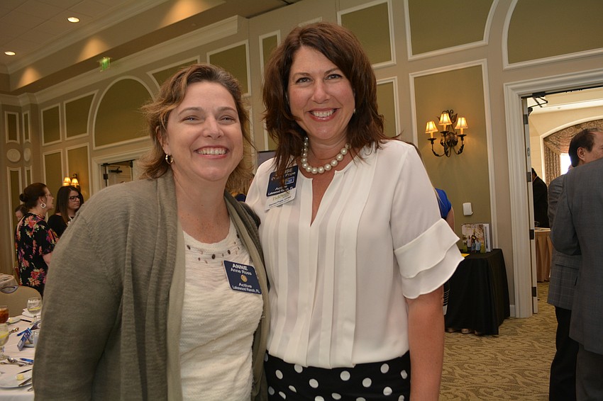 Rotary Club member Anne Ross, executive director of Lakewood Ranch Town Hall, greets fellow Rotarian Denise Pope, of Tidewell Hospice.
