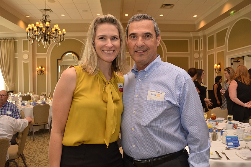 Kat Hughes, with Observer Media Group, makes sure to say hello to her dad, Rotarian Jim Wingert.