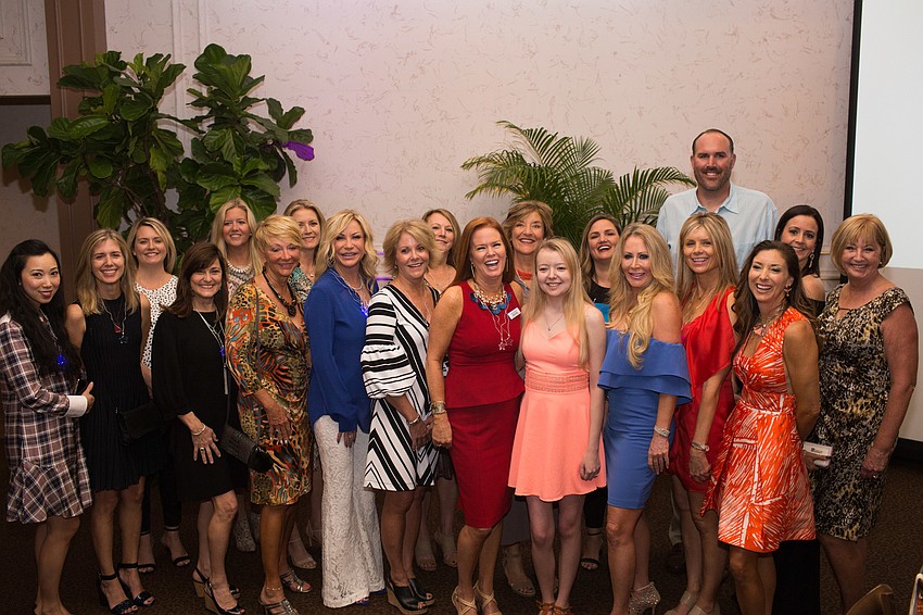 The Cooking for Wishes committee poses with Make-A-Wish recipient Emily Barley.