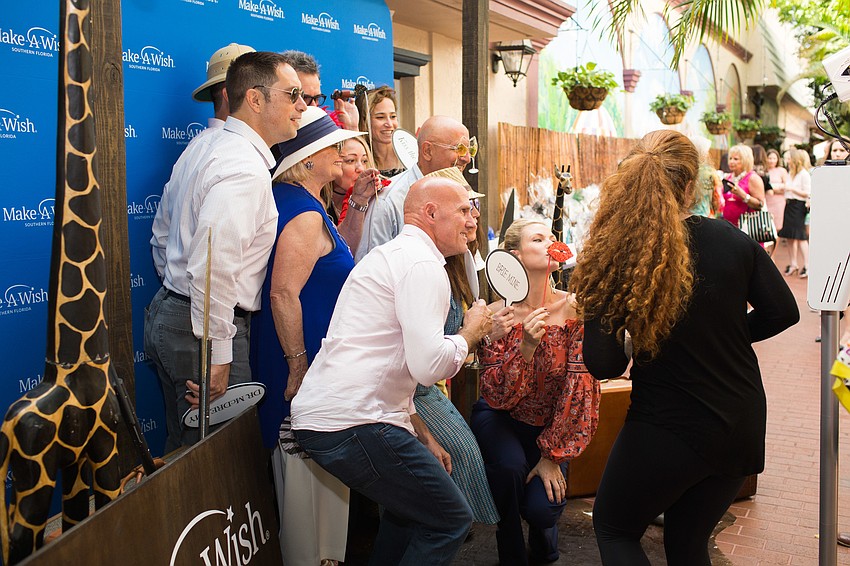 Guests take photos in the African safari-themed booth.