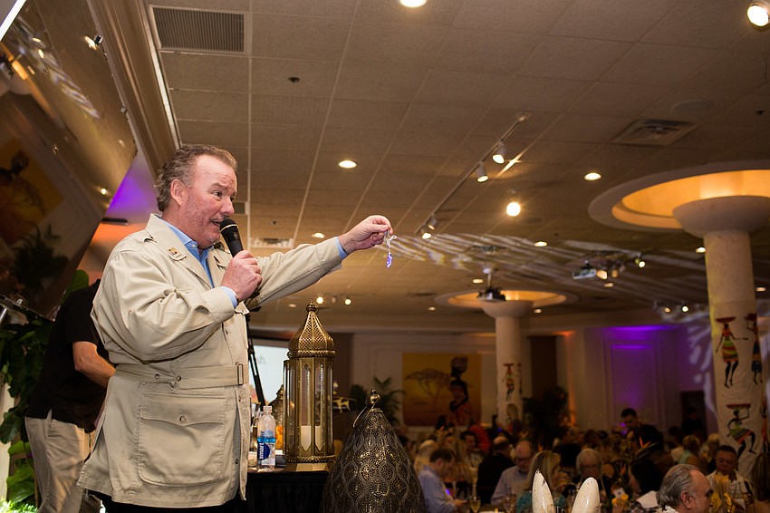 Michael Klauber sells star necklaces for the raffle.