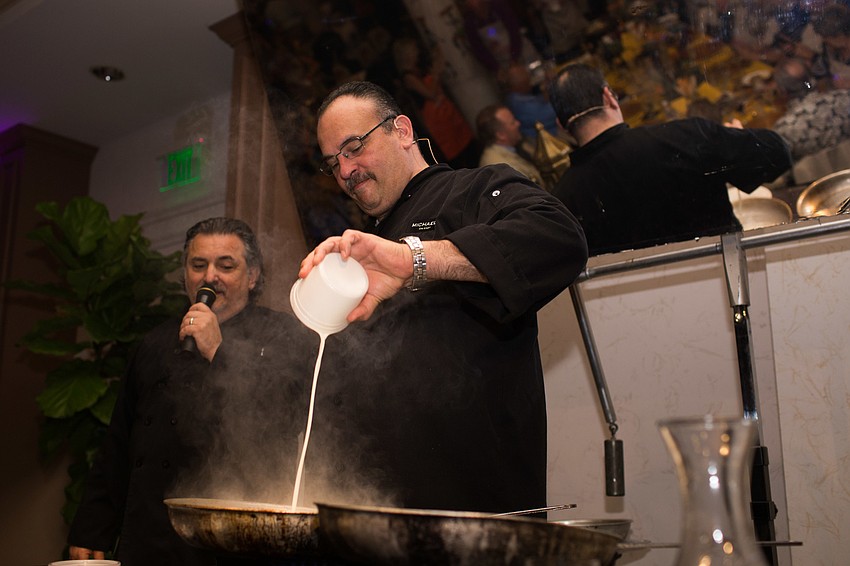 Executive Chef Jamil Pineda pours the cream in the pan for the second course.